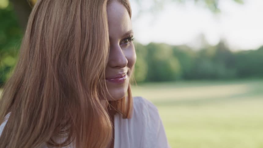 A woman is sitting outdoors in spring