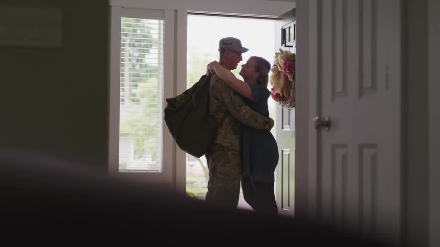 Couple hugging next to the door in a romantic way