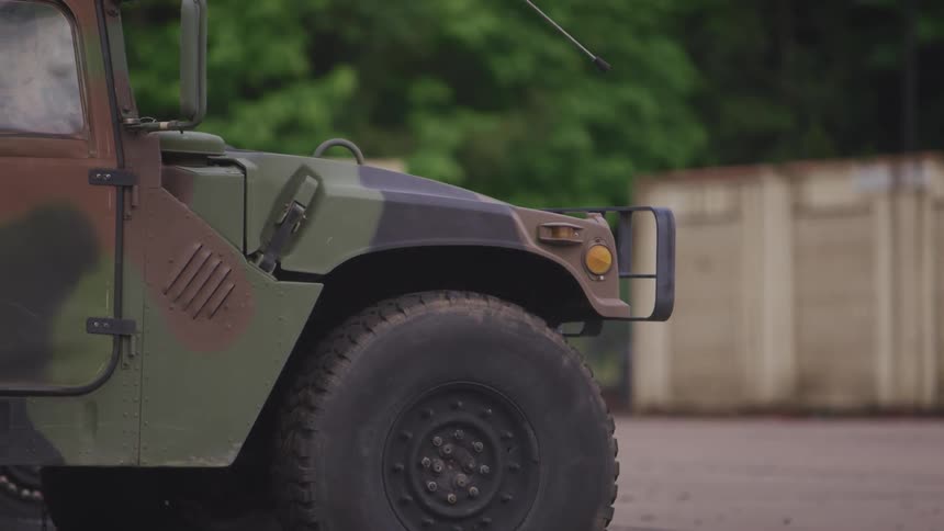 A panning shot of a military jeep