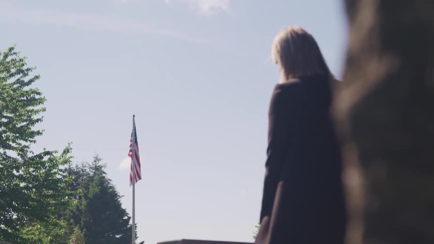 A woman is standing outdoors in spring