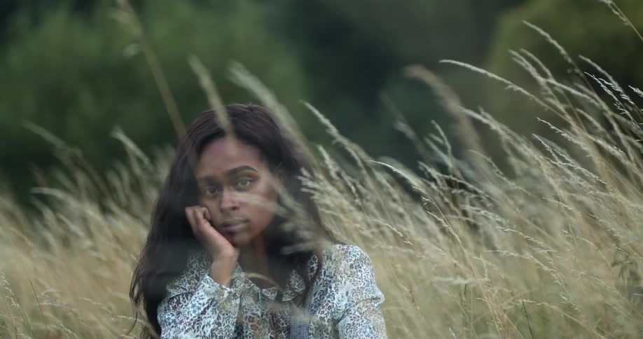 A woman sitting in a field