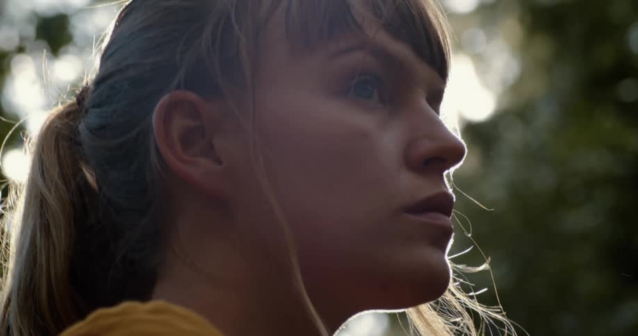 A woman turning and looking into the distance