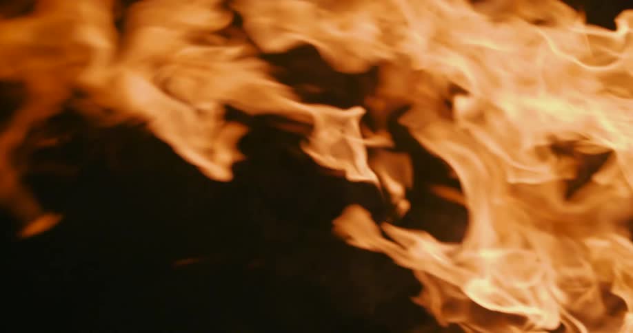 Fire blazes brightly as flames burn high in the darkness