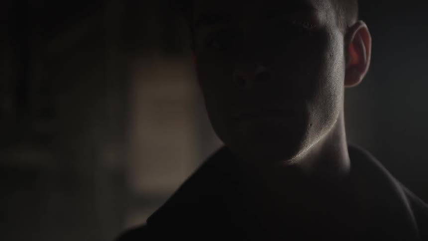 Man looks around dark room