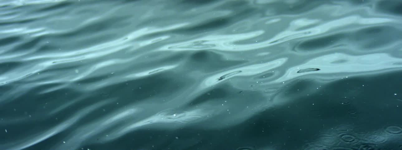 Water rippling and gentle waves with light reflecting on water