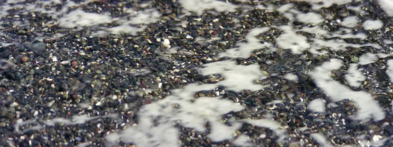 Water from the river is flowing against the rocks