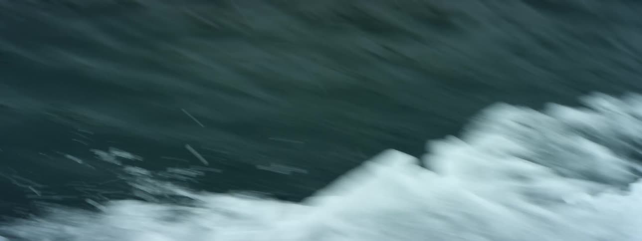 Moving on the surface of a body of water with white waves