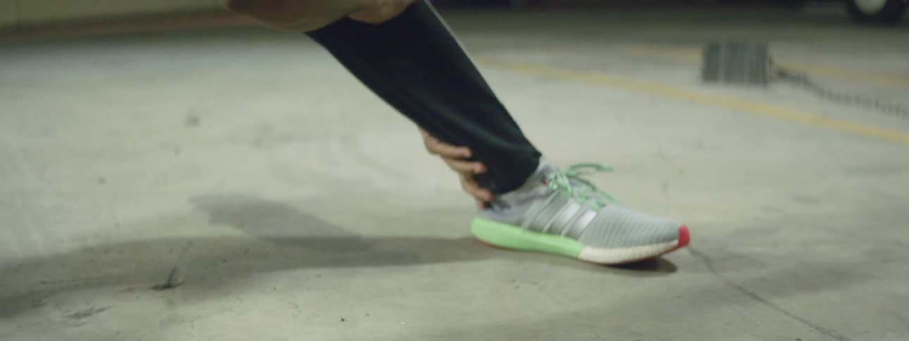 Black man stretching out wearing running shoes