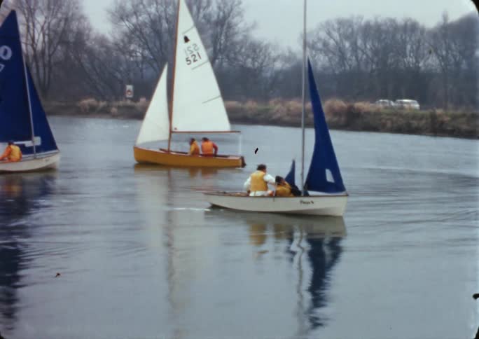 People sailing on the water close to the shore