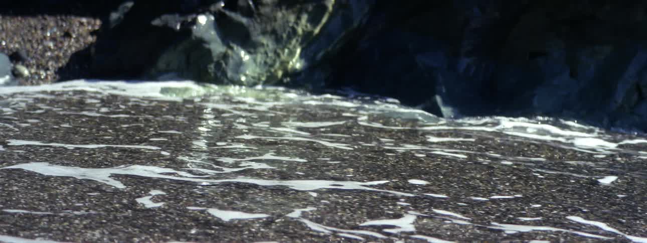 Tide water coming in and out on a shore on a beach at daytime