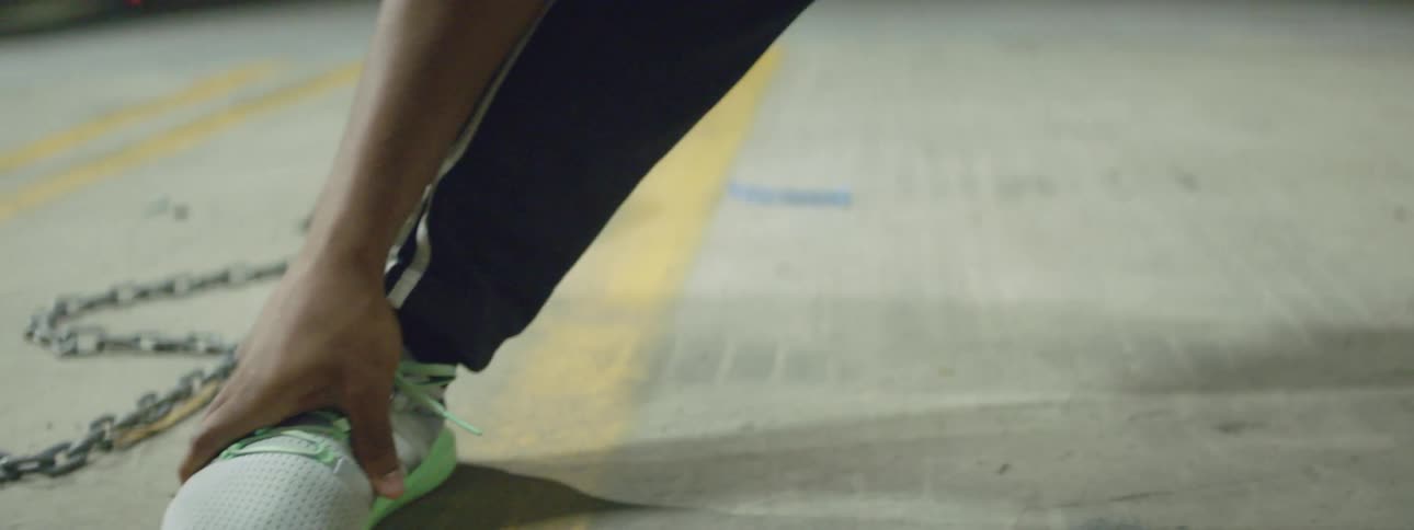 Black man stretching out while wearing fitness clothing