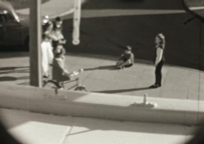 Children skipping and playing outside on a sidewalk