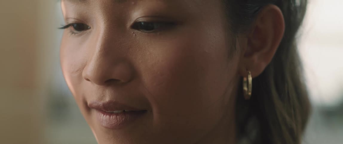 A woman turns her head looking at something