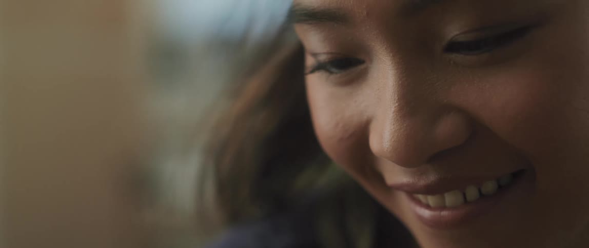 Woman smiles as she looks down