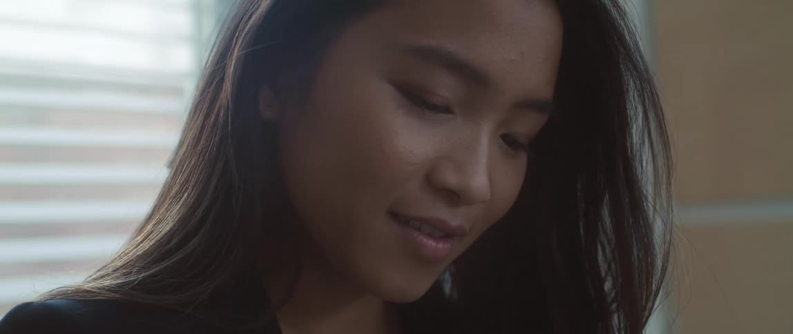 A young woman indoors talking and laughing