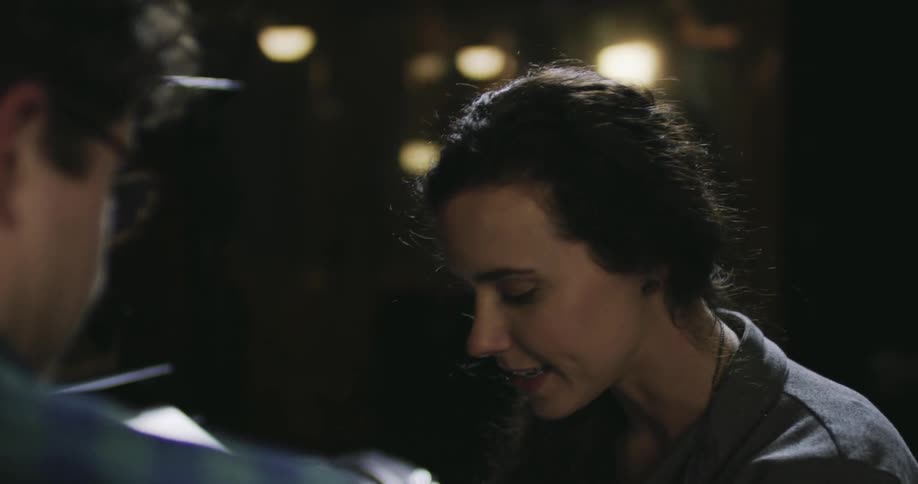 A man and woman are talking at night