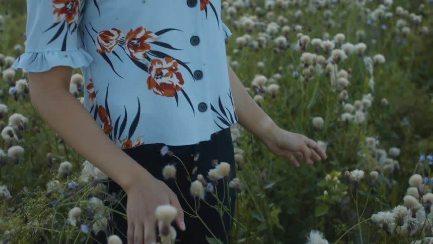 A woman is standing outdoors in spring