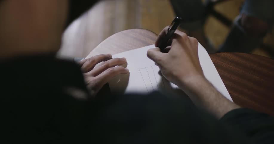 Man sketching a chart on a piece of paper