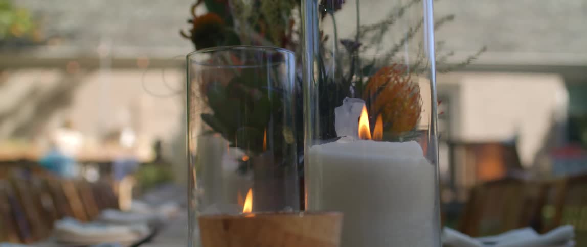 A candle burning on a table at a restaurant