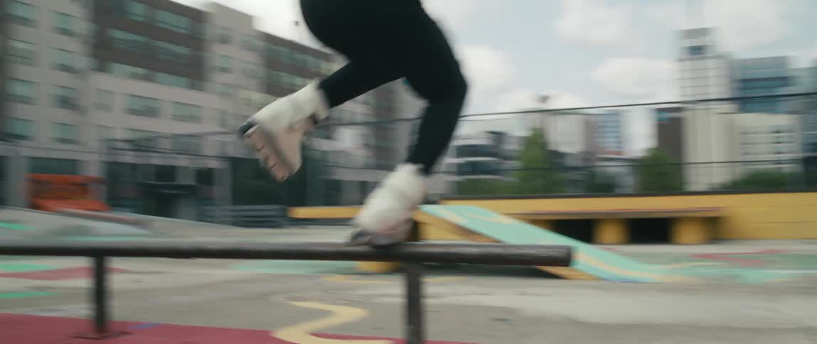 A teenager rollerblading at a skate park