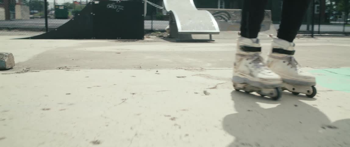 A man is rollerblading in the park