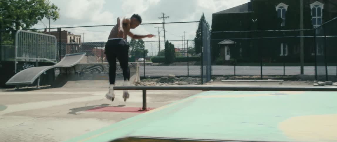 A guy is roller blading in a skatepark