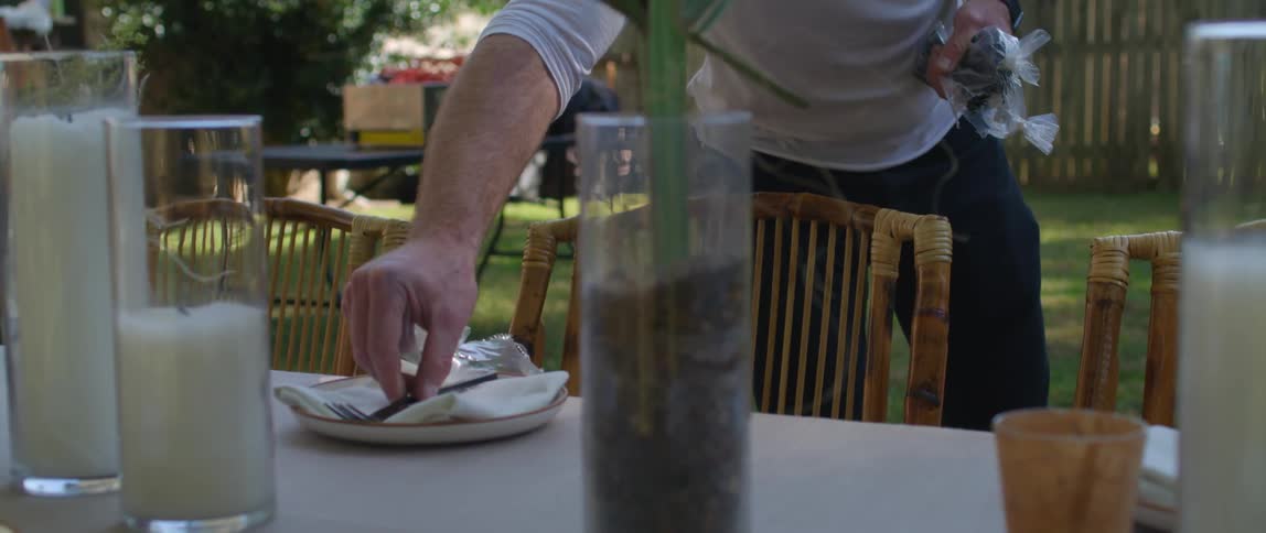 A man preparing a table to be eaten at