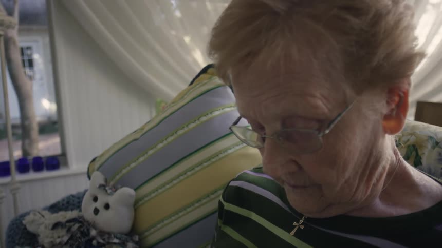 An older woman sits and reads