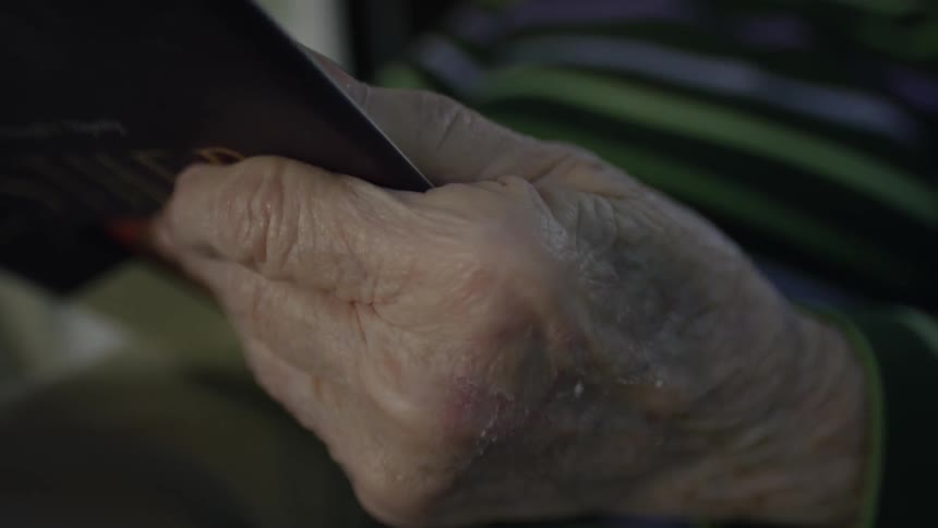 Close up of a person sitting with a book in their hands