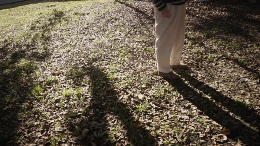 A man is standing on a green field