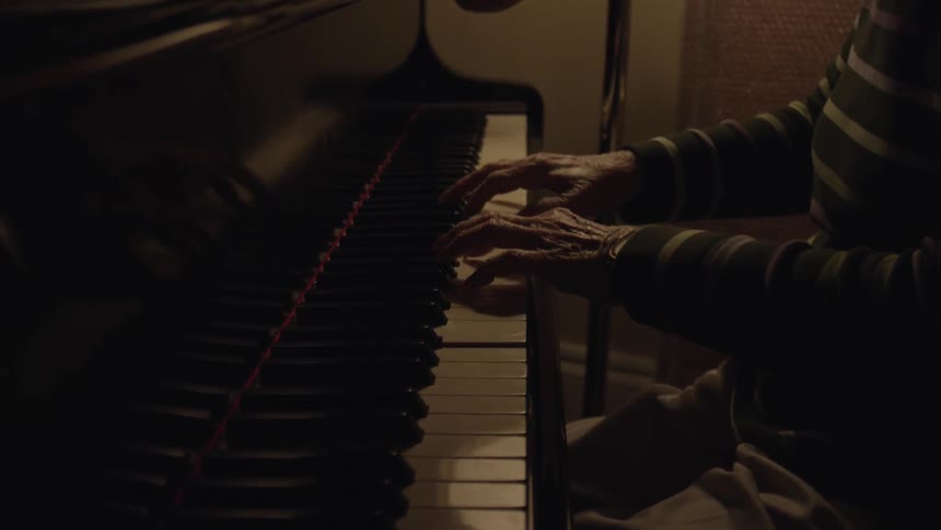 Close up of a person's hands playing piano