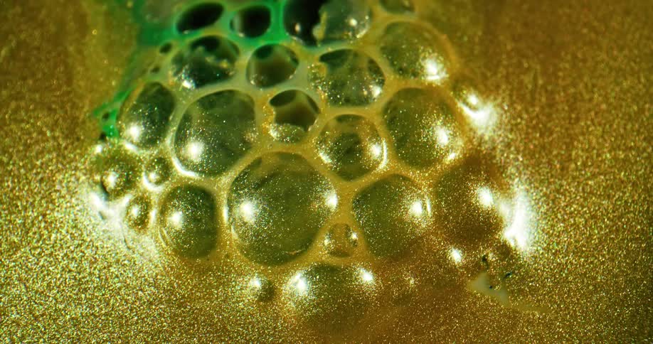 Glittering gold surrounds a web of bubbles