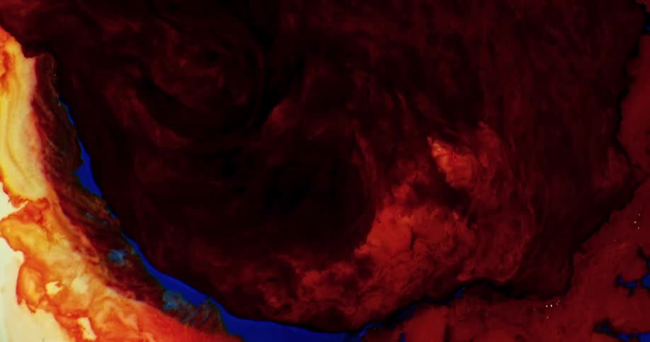 A red abstract liquid being poured into a blue and orange mixture