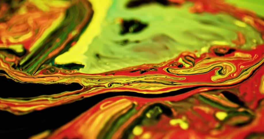 Bright colorful liquid ink spreading in swirling chaotic psychedelic patterns