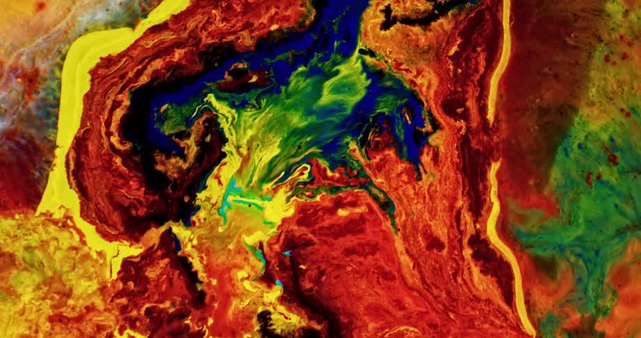 Colorful bright inks swirling over a surface in chaotic psychedelic patterns