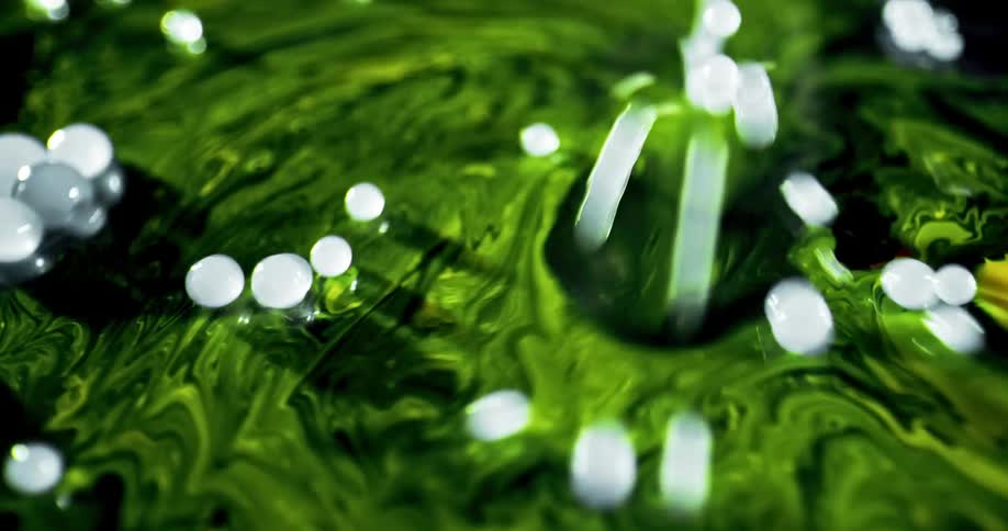 Balls bouncing on a thin layer of liquid
