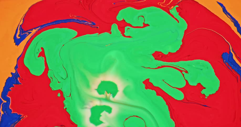 Liquid bright green ink pouring in abstract chaotic patterns over red orange and blue inks