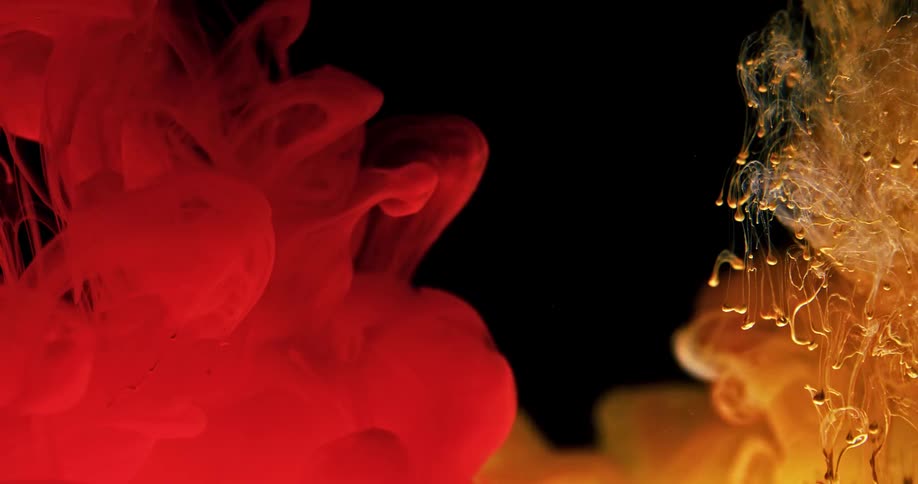 Red and yellow liquid poured separately then flowing together