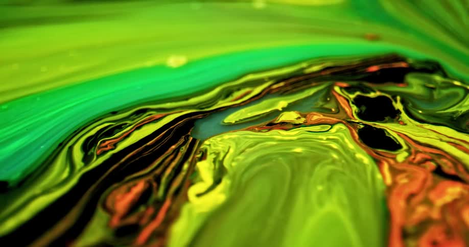 Colorful green liquid yellow ink flowing in abstract chaotic patterns
