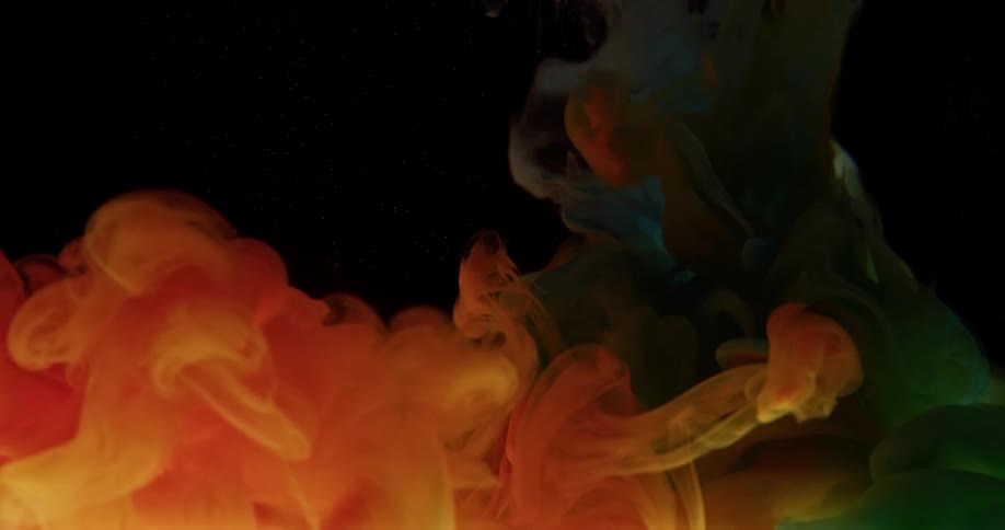A jet of blue smoke passes through an orange jet and the two colors blend artfully