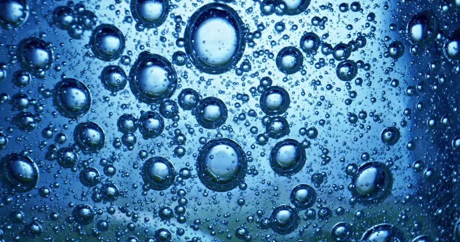The sunlight shining down on bubbles in liquid