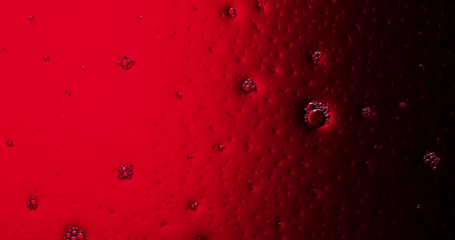 Bubbles on a pitted curved orange surface pop