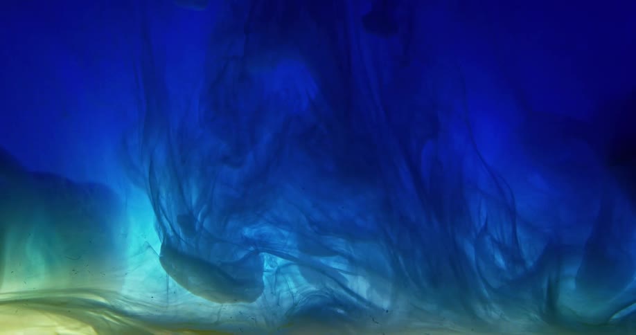 Dark blue liquid ink flowing down a tank in waves
