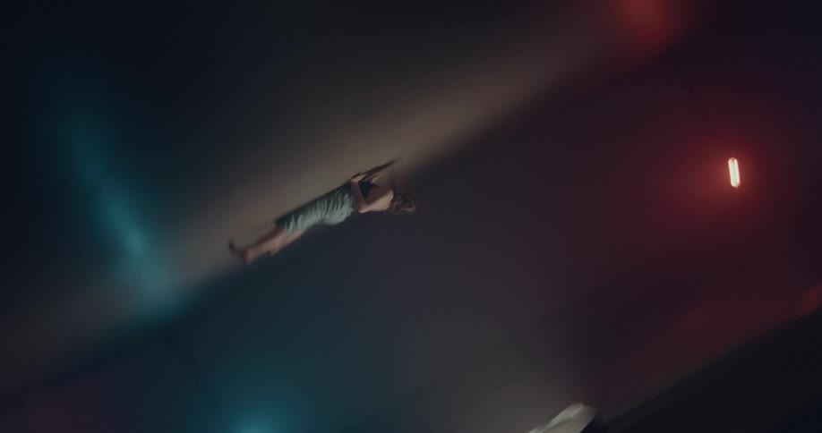 A woman doing modern dance in an empty room