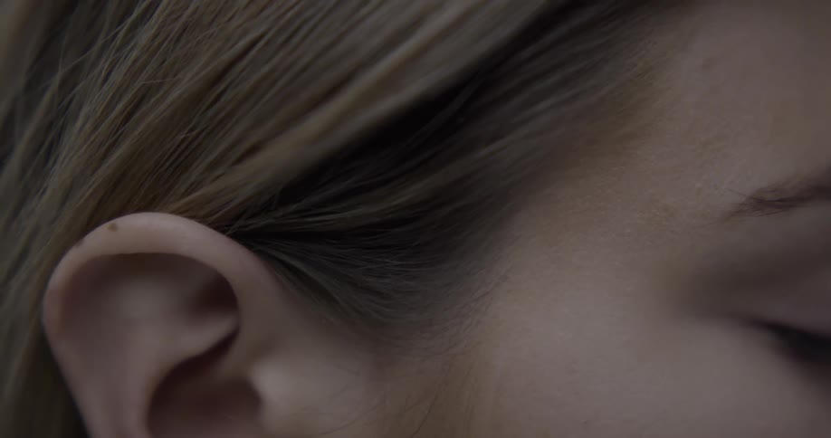 Close up of the ear on a young woman face
