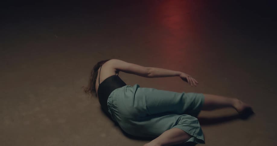 A female on the floor performing dance movements