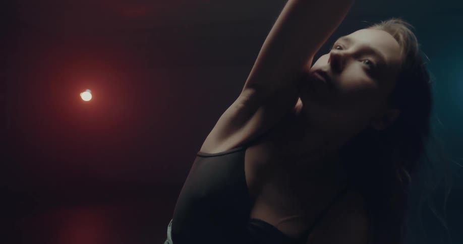 A woman dancing under bright lights