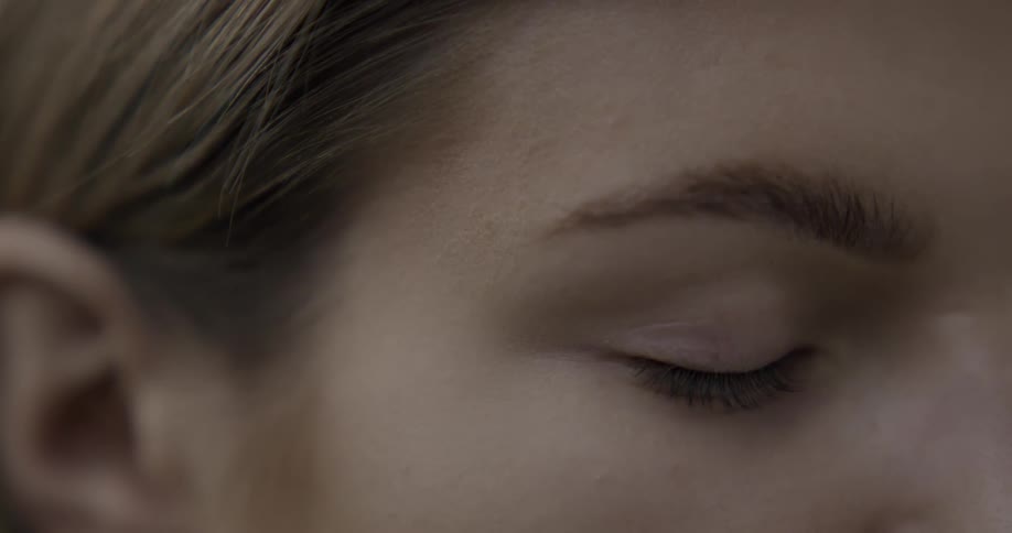 Womans eyelid flutters while her eye is closed