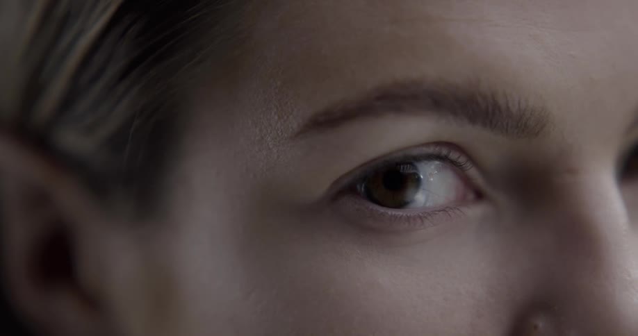 A woman opens and closes her eye