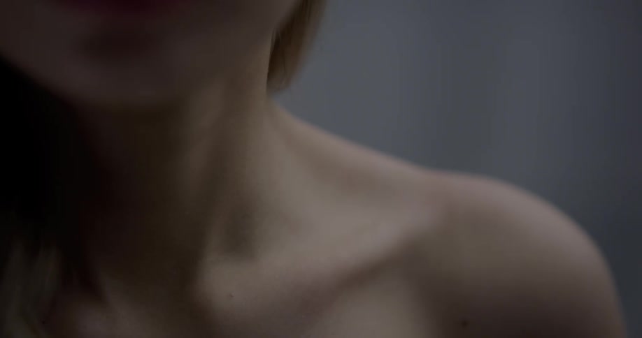 A woman with bare shoulders and her chin visible